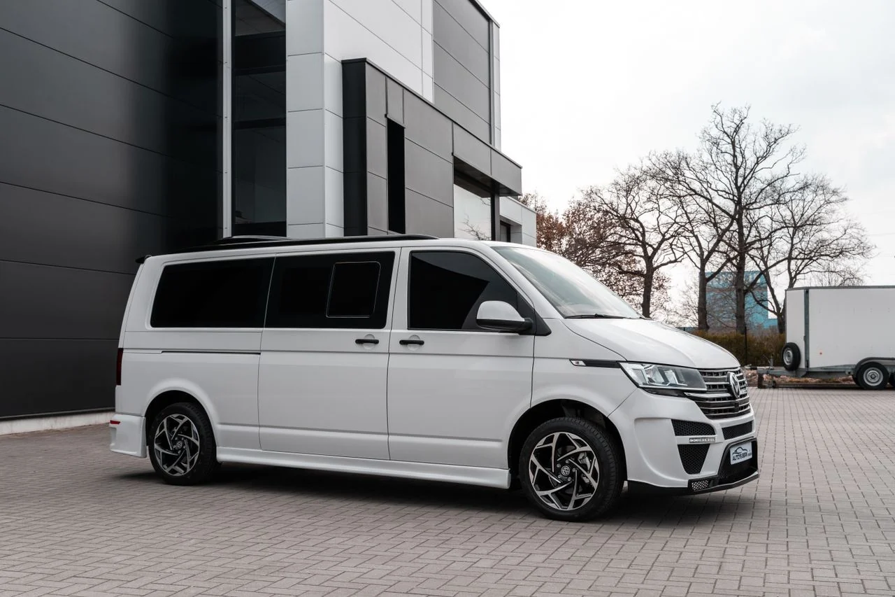 Passenger van, side view. Illustrative transport photograph; not the operator fleet or confirmed vehicle model.