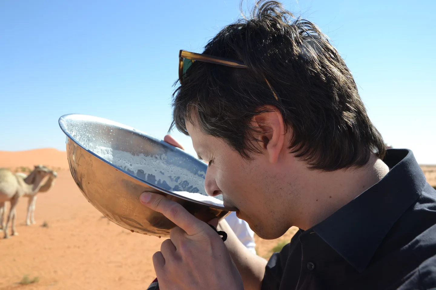 A man tasting camel milk in Saudi Arabia.