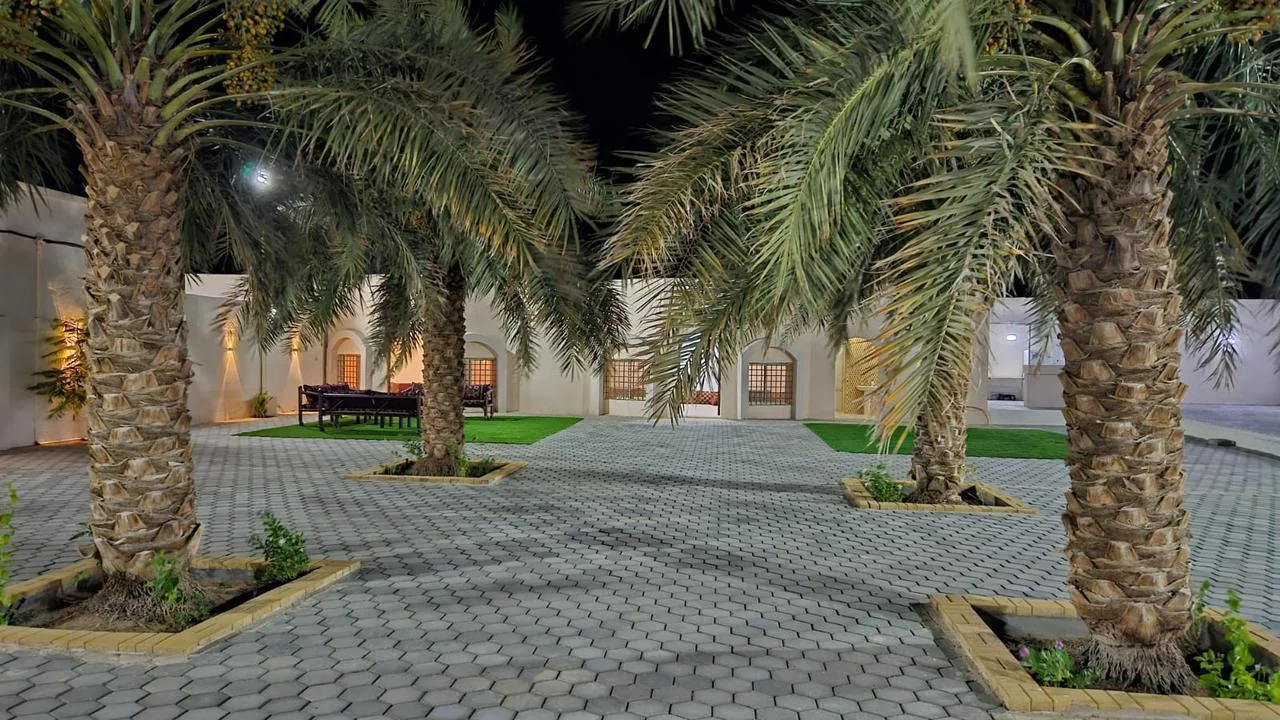 The private Istiraha courtyard with palms and arches.
