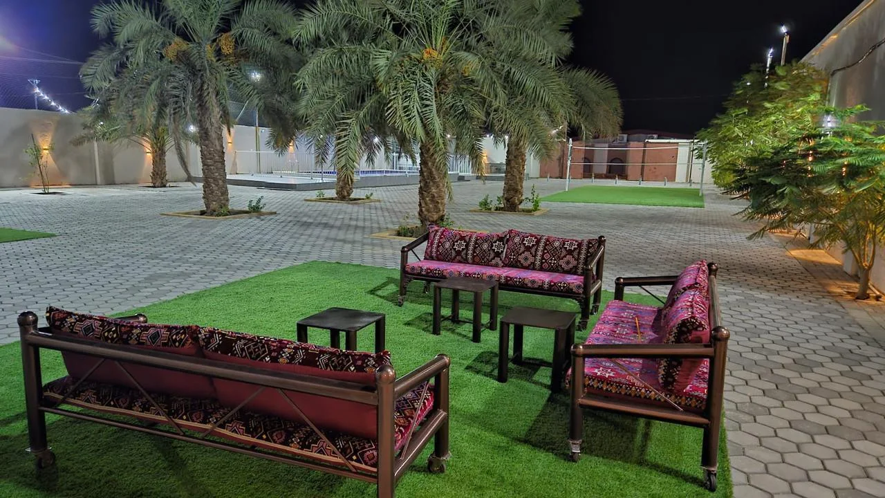 Outdoor seating beneath palms at the private Istiraha.