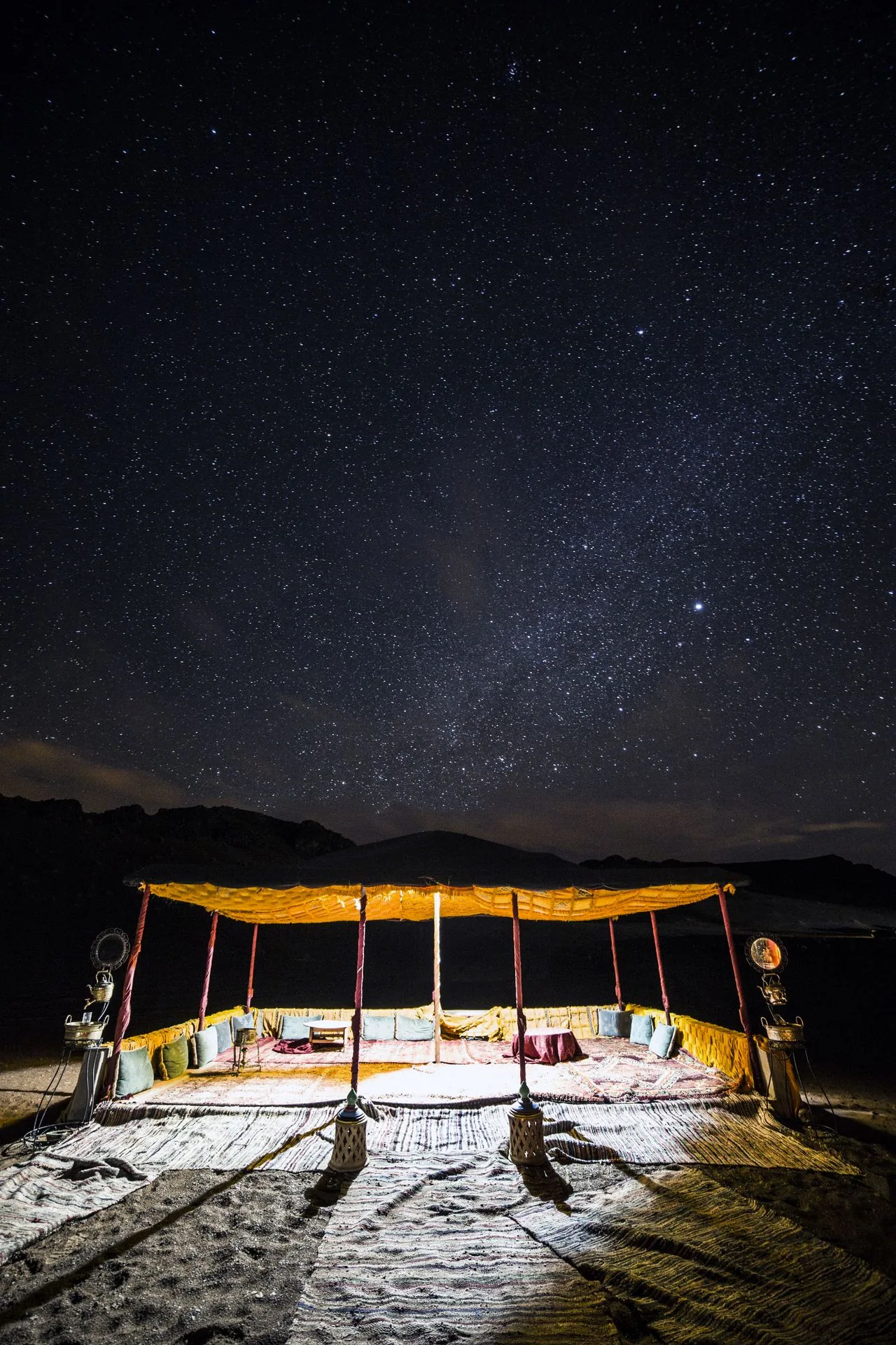 Desert lounge tent under a starry sky.