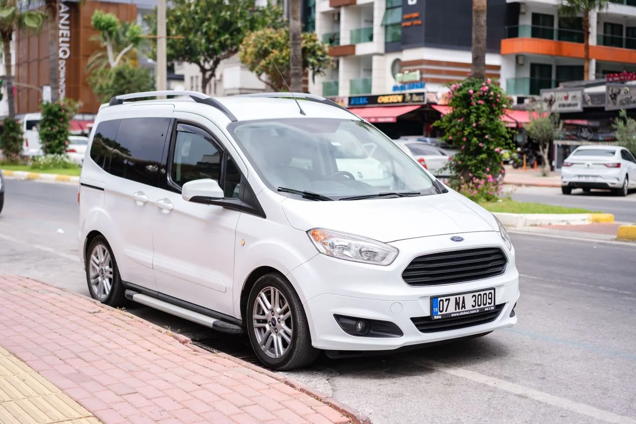 White minivan on a city street.